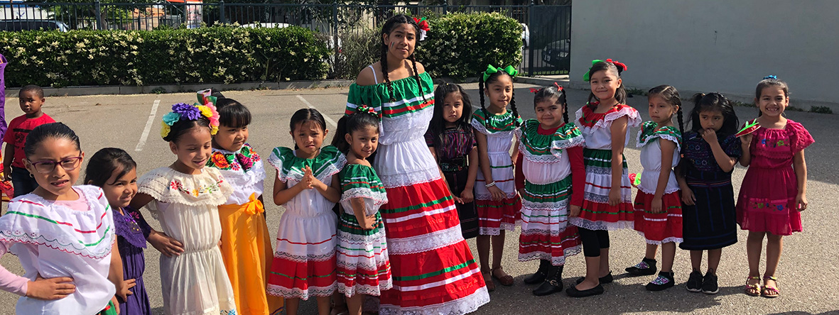 Woman and girls dressed in colorful, festive dresses